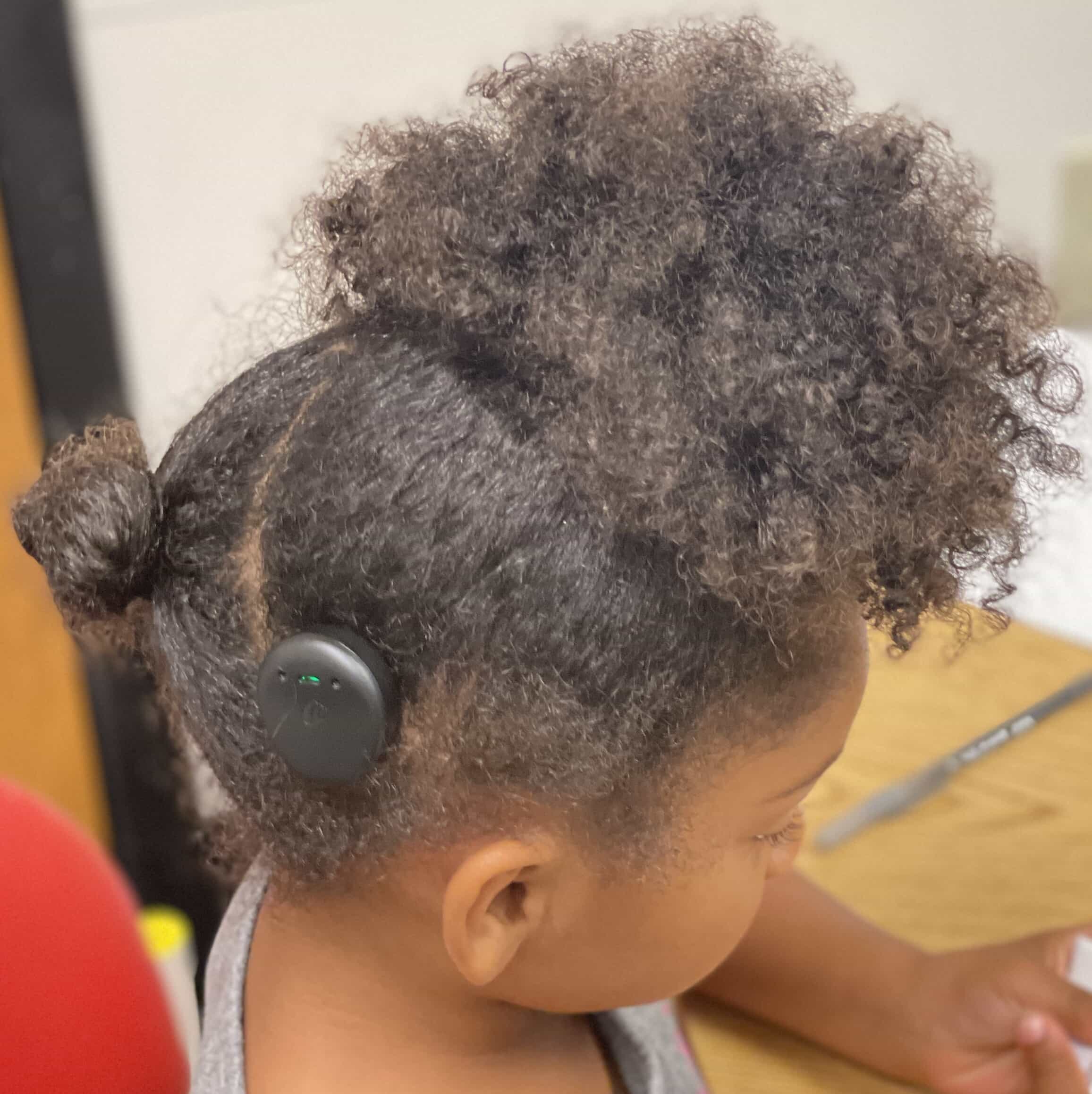 little girl with hearing device